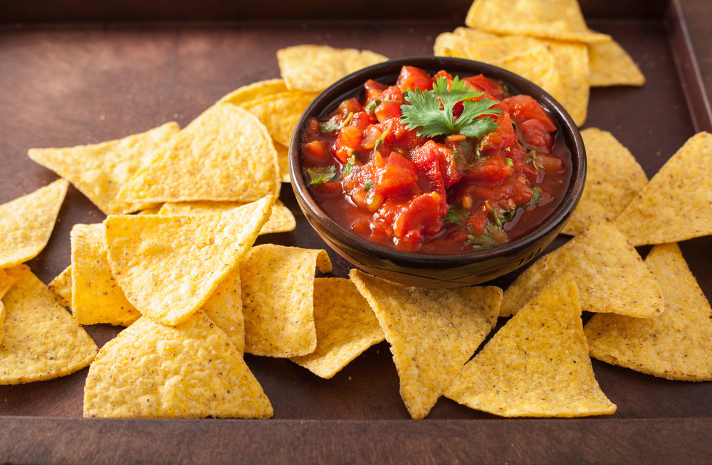 close up of bowl of fresh salsa with chips around it, served at Mexican restaurant in El Paso