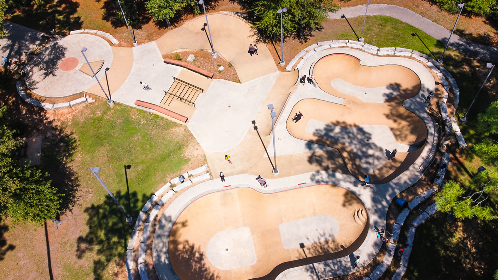 An aerial view of a skate park on a bright sunny day