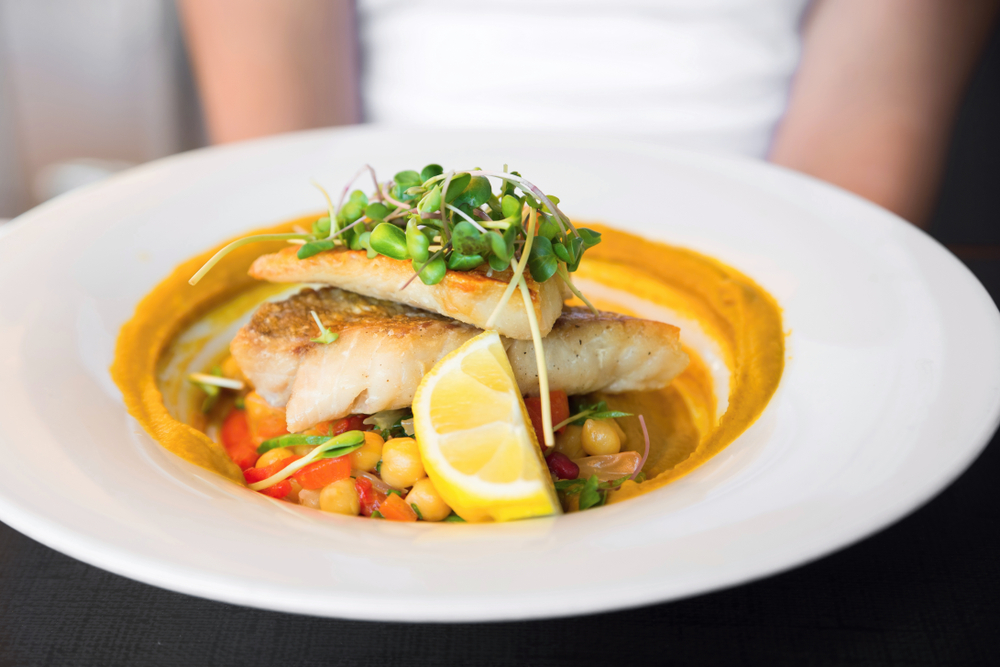 a local caught snapper pan fried over a puree of sauce and served over veggies