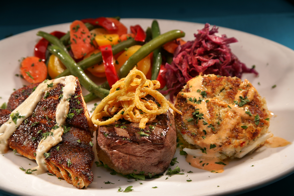 surf and turf at Katz 21 steak, cajun snapper and crab cakes with veggies and red slaw