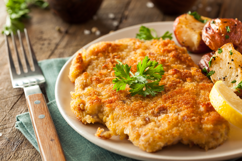 Schnitzel with lemon and potatoes on a plate