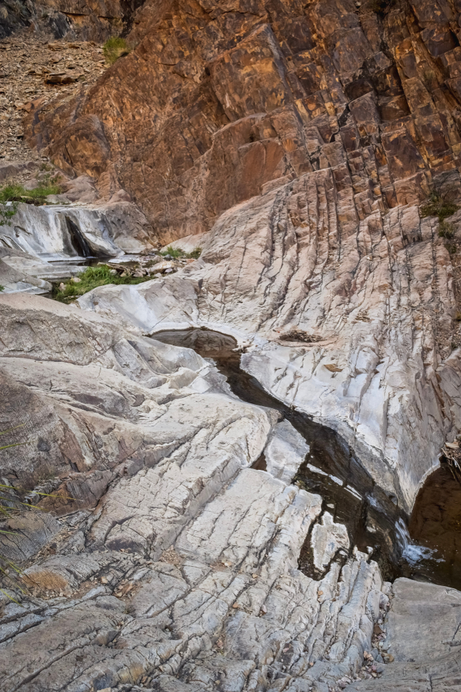 light waterfall cascading down a rock face. 