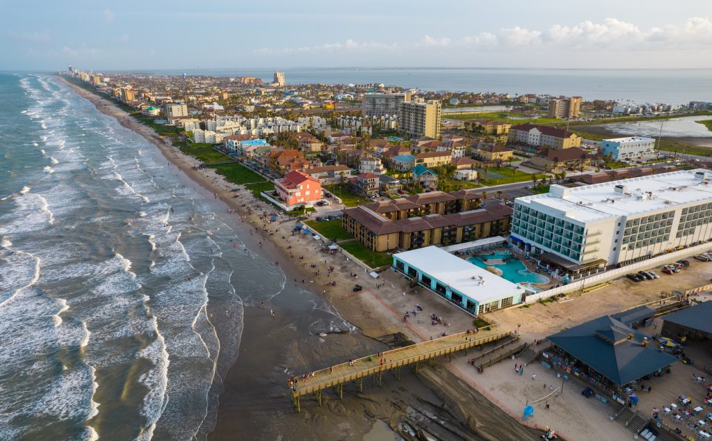 Drone view of a beach with pier