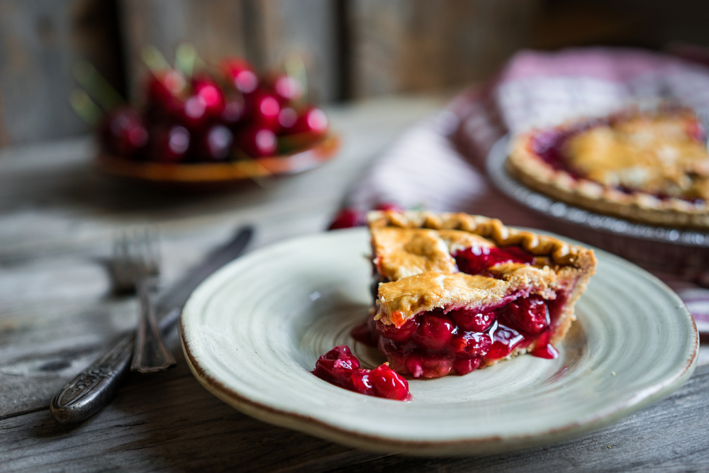 Plate of Cherry Pie with out of focus pie in the background at rustic Restaurant in McKinney 