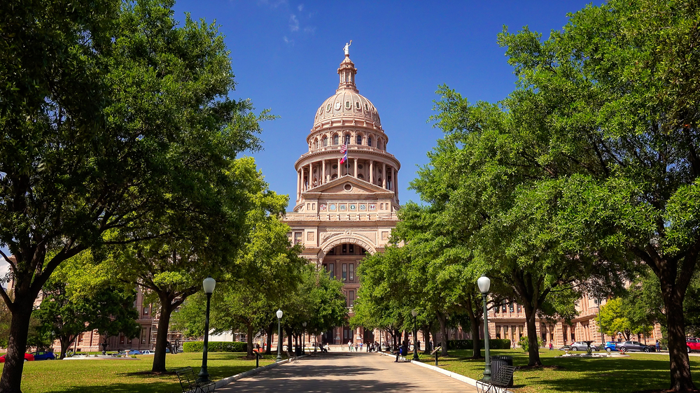 Texas State Capitol building, one of the best things to do in Austin. Main dome of building at center framed by trees