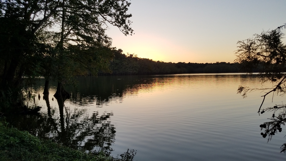 sunset over calm waters at Lake Houston.