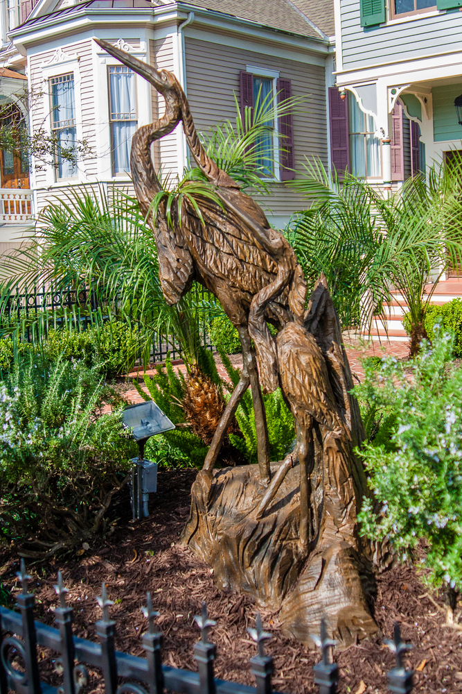 An old oak tree that was destroyed was carved into a bird sculpture by a local artist. 
