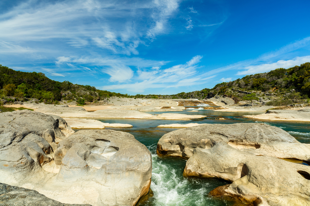 Pendernales Falls is near John City Texas with large rocks and water flowing through 