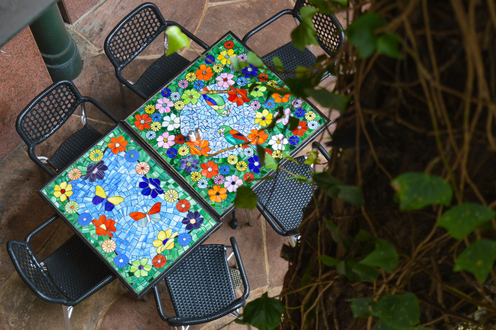 birds eye view of colorful mosaic table top with empty chairs at restaurant in San Antonio 