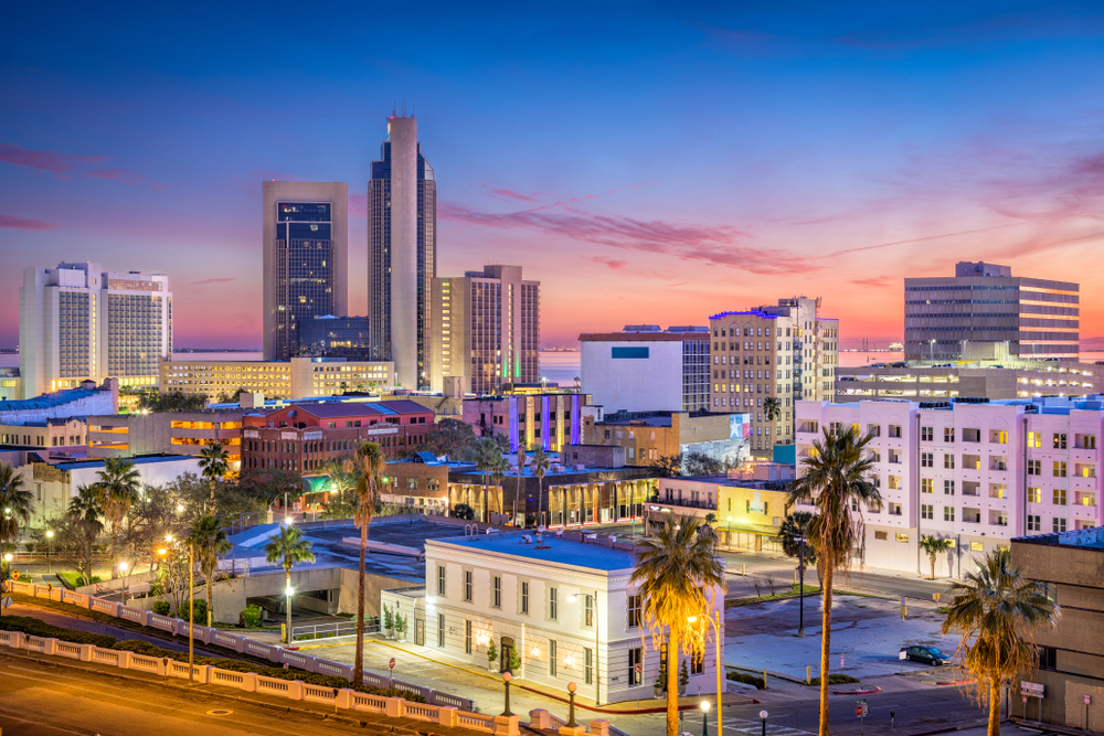 Corpus Christi's skyline at dusk is lit up with street lights, hotels, and more.