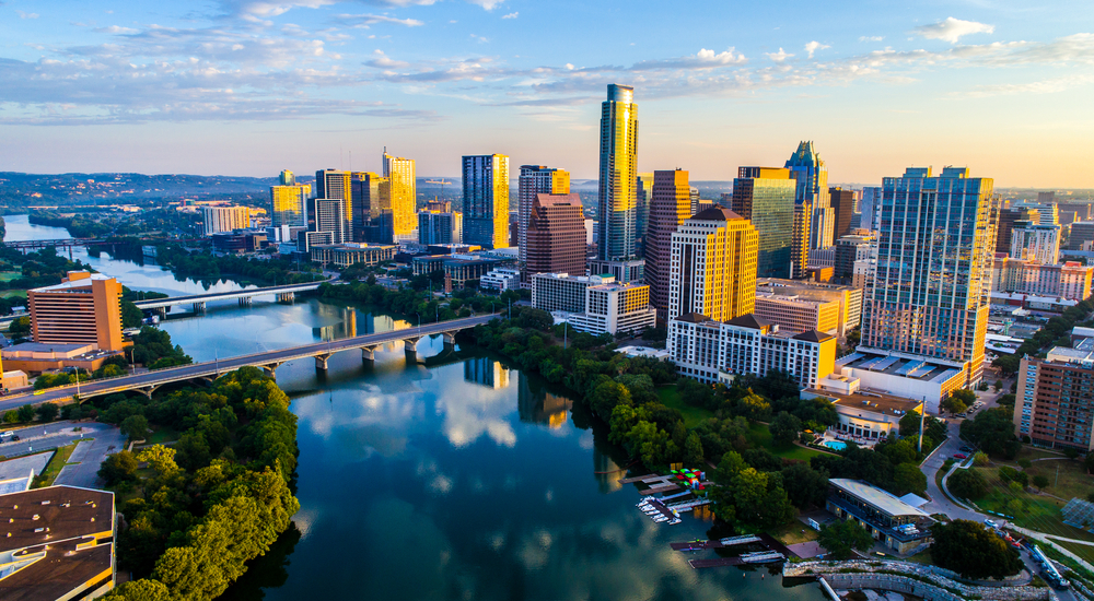 The skyline of Austin Texas in the morning sun by a river.