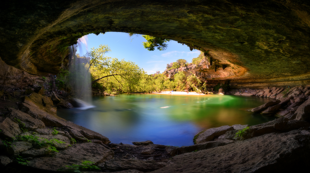 The carved out cave in Hamilton's Pool looks out over the water at one of the best texas vacation spots
