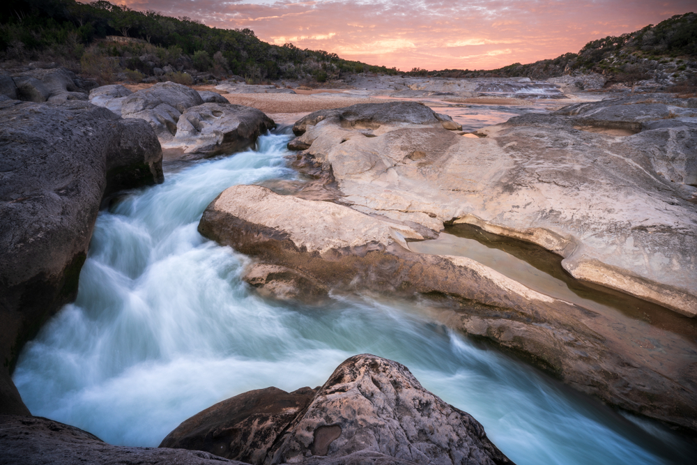 sunset photo of pedernales falls. one of the great hiking trails in austin with waterfalls