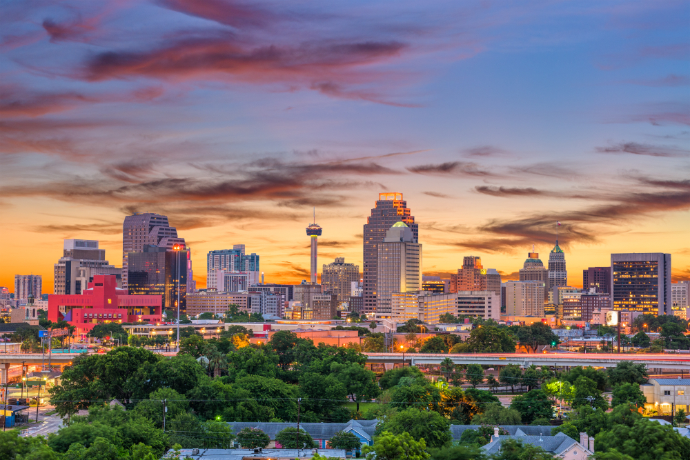 A photo of San Antonio at sunset. Beautiful place to start or complete a Dallas to San Antonio road trip.