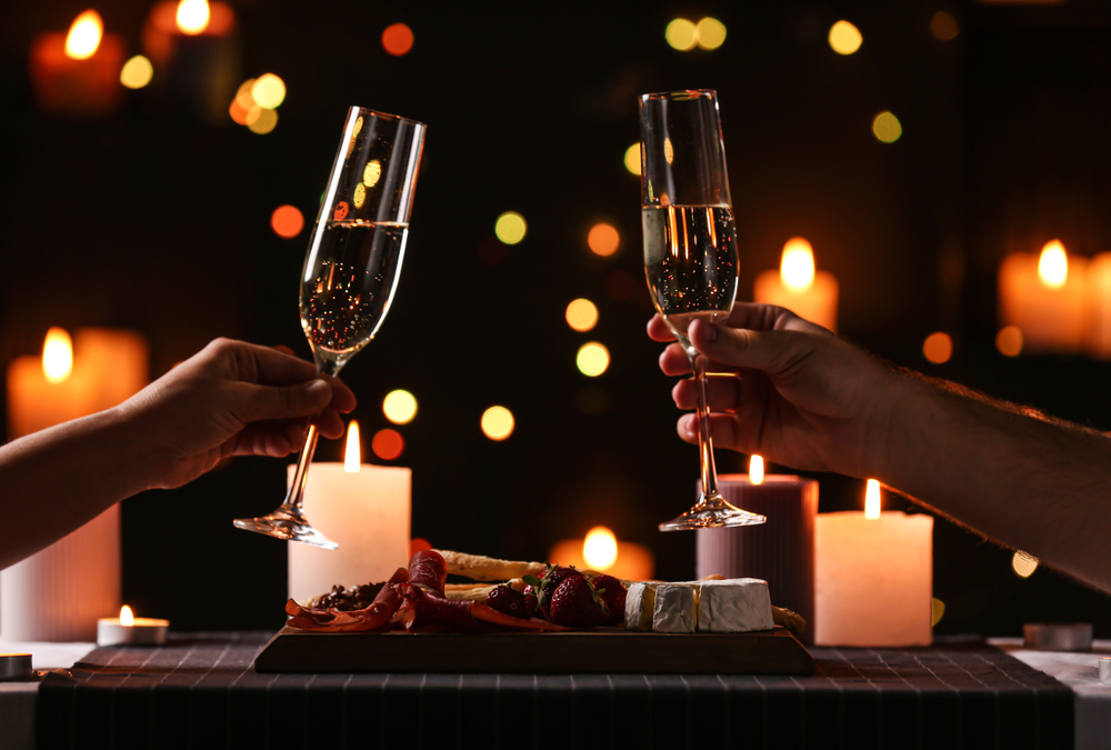 couple with glasses of champaign on a romantic dinner date night in dallas