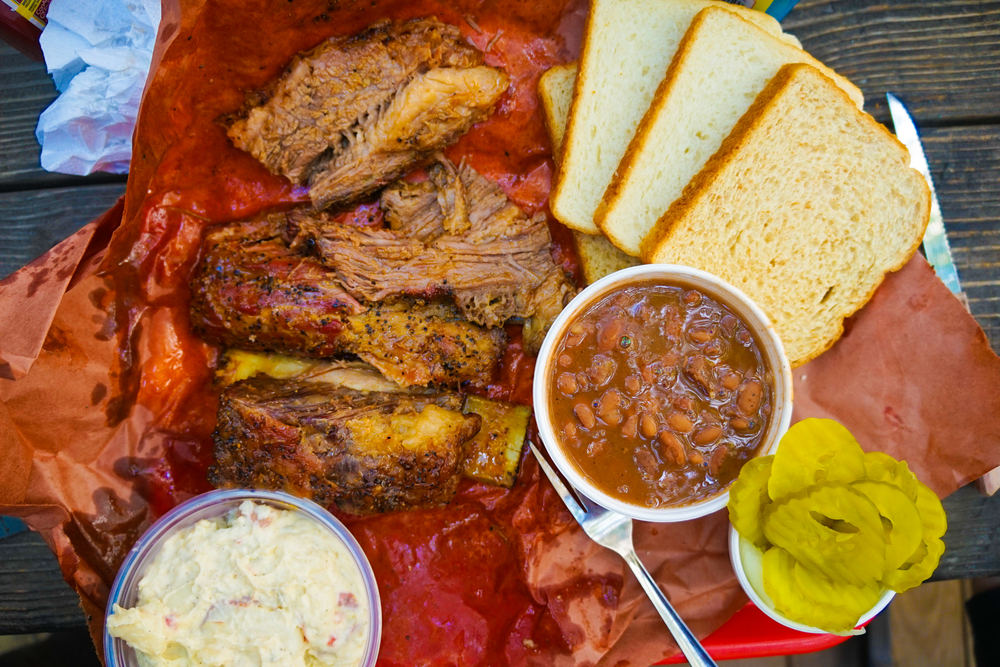 Food in Austin is so important: this image represents true Texan culture with cornbread, baked beans, and BBQ. You can do a fun date night in Austin with things like the secret food tour, that bring you this kind of yummy meals! 