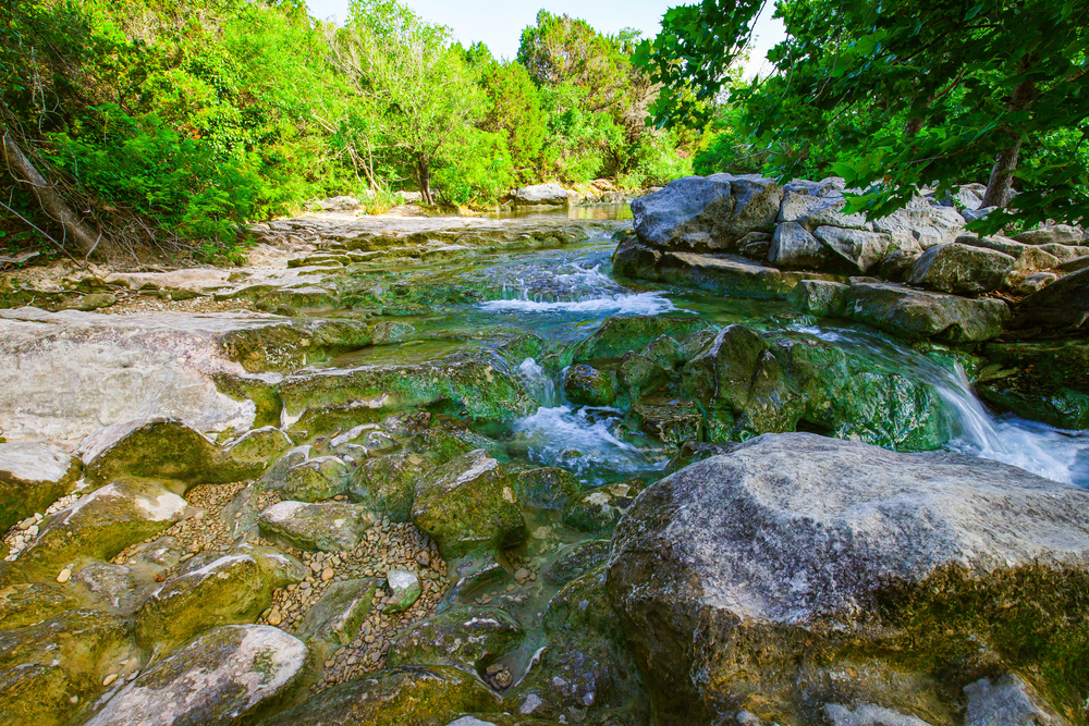 Date night in Austin can be full of adventure too: this image of twin falls features a stream that is perfect for dipping your feet in or shallow swimming post-hike.