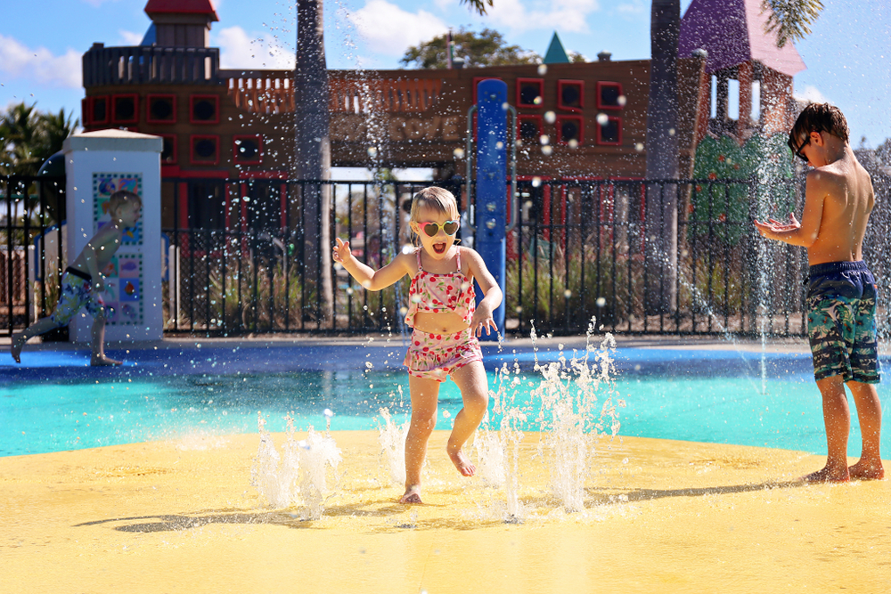 Photo of kids playing on splash pad at Bahama Beach, one of the most affordable water parks in Texas.