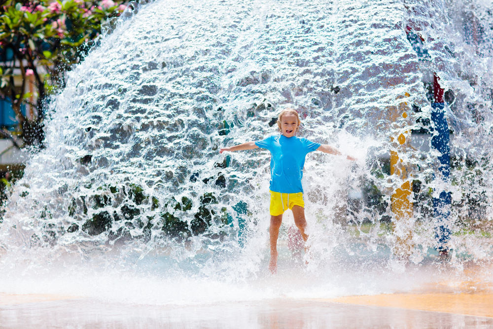 Photo of a young girl playing in the water at Pirate's Bay. 