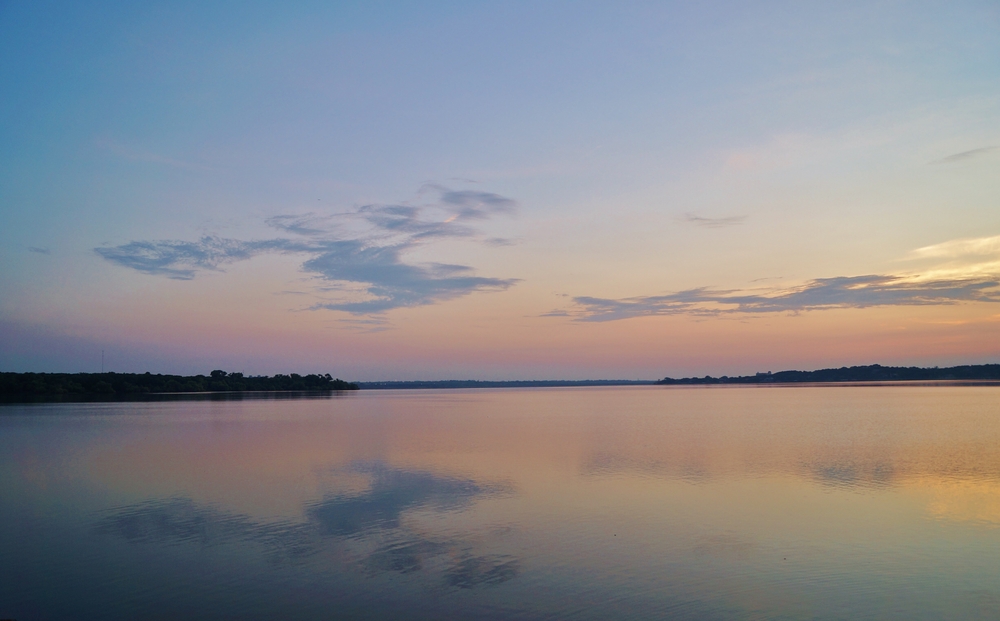 A sunset at Arlington Lake proves that the lakes in Dallas have the best colors: the sky is pastel blue, yellow, pink and purple. And the water is calm.