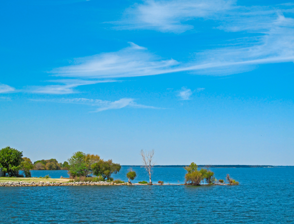 Of all Lakes in Dallas, lake Tawakoni is vividly blue and some of the land stretches far into the water like a mini peninsula, as shown in this photo. 