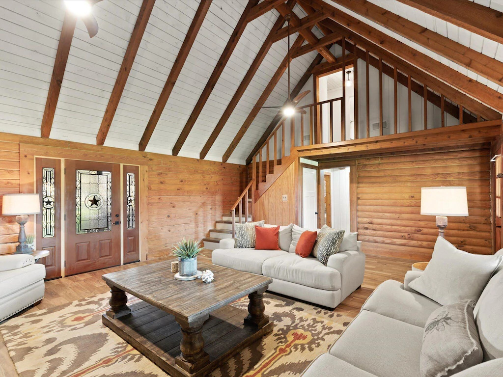 Photo of the vaulted ceilinged living space in the Log Cabin on the River Front.