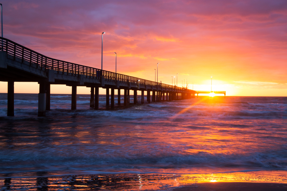 Photo of the lighted fishing pier at sunset at Padre Balli Park.