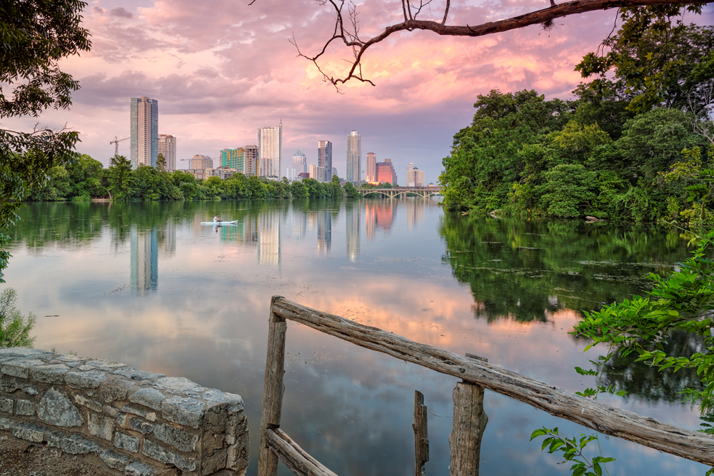 Photo of Lady Bird Lake and the Austin skyline at sunset.