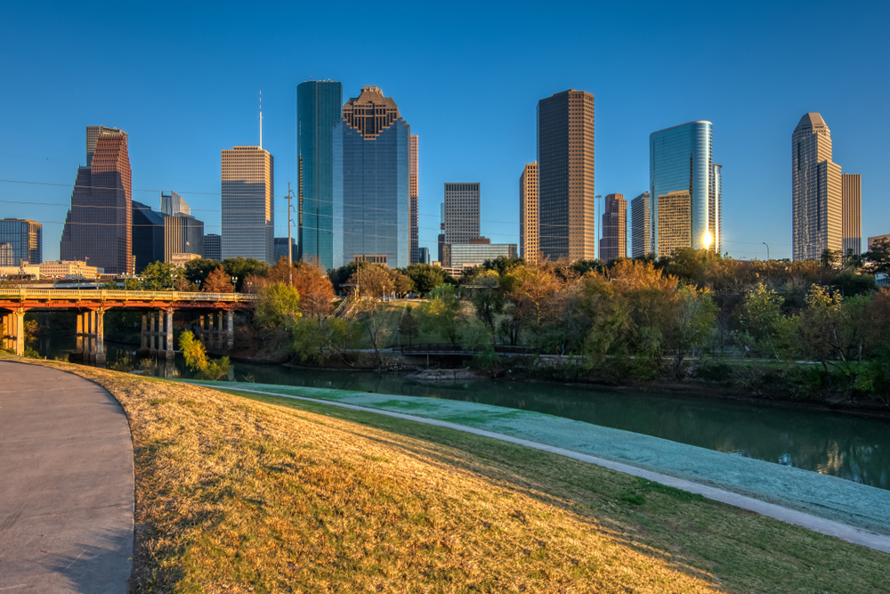 Picture of one of the hiking trails in Houston with a view of the river and skyline. 