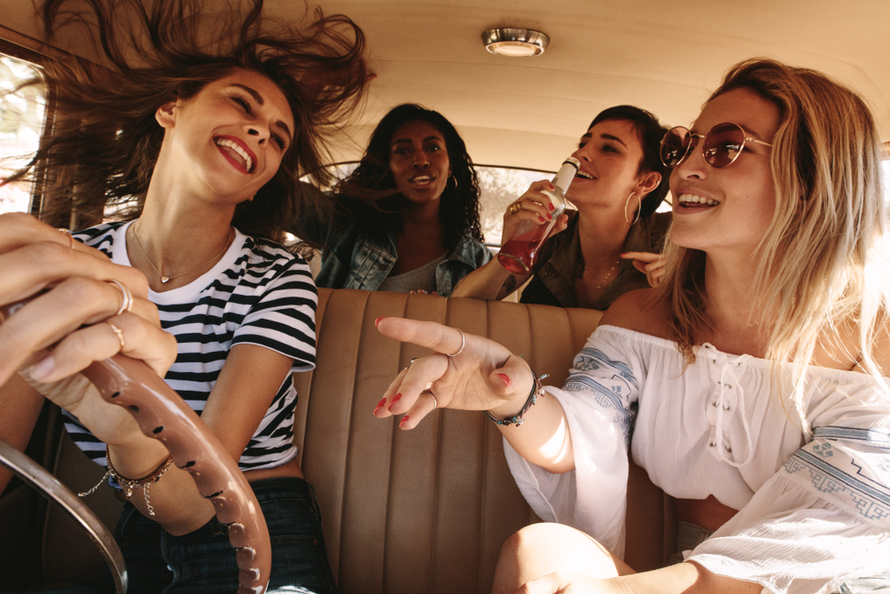 Photo of women having a great time on a road trip to and from Dallas!