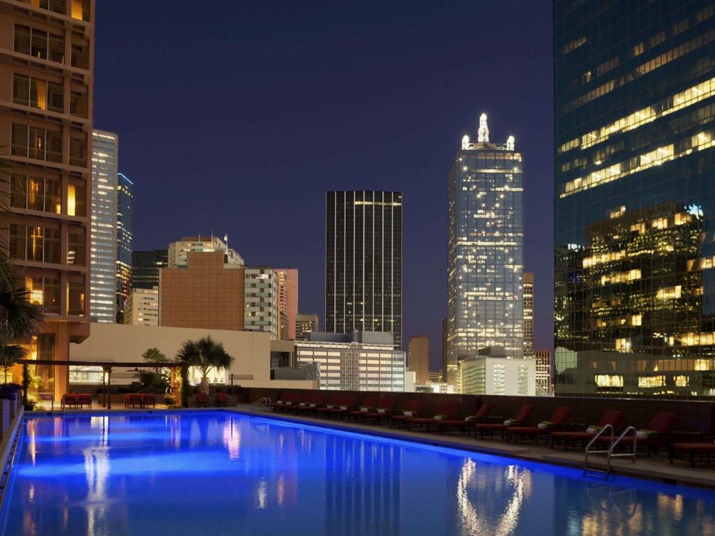 The view of the Dallas skyline at night from a hotel rooftop pool in Dallas. 