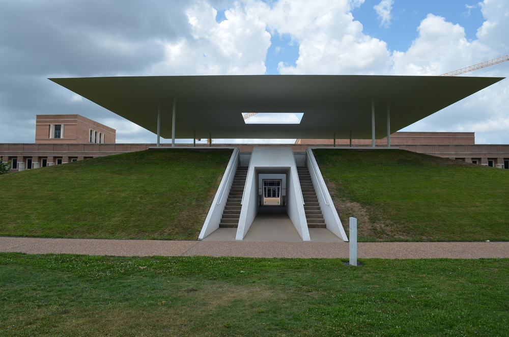 The front of a very modern pyramid-style structure on the Rice University Campus on a cloudy day