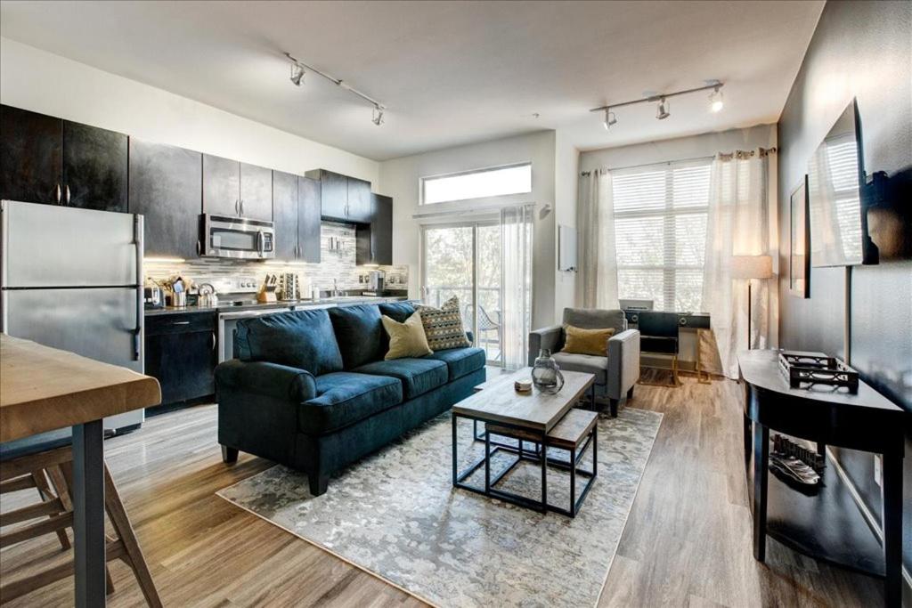 This home features a nice kitchen and blue couch that faces a TV, making it where to stay in Dallas if you need more than just a room. 