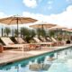 pool with lounge chairs and umbrellas at one of the best places to stay in Austin