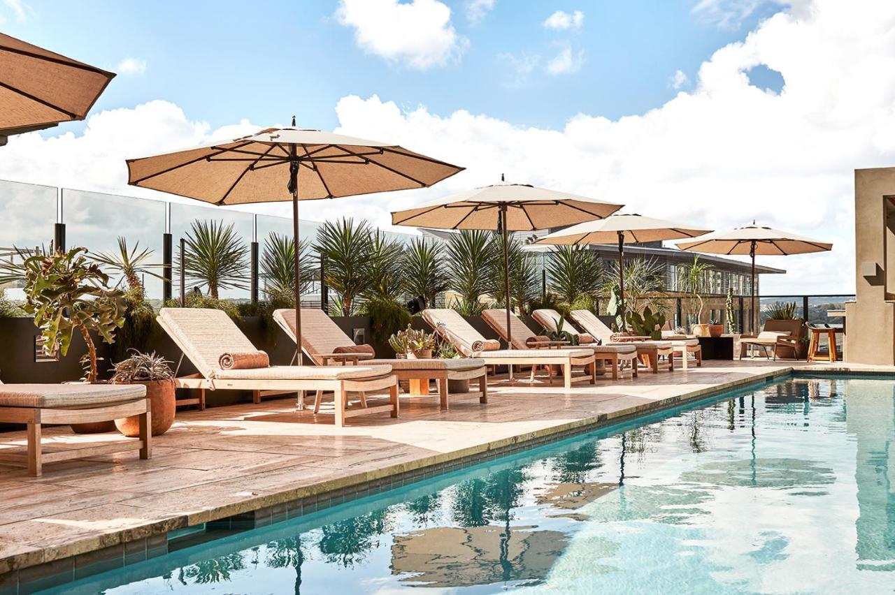pool with lounge chairs and umbrellas at one of the best places to stay in Austin