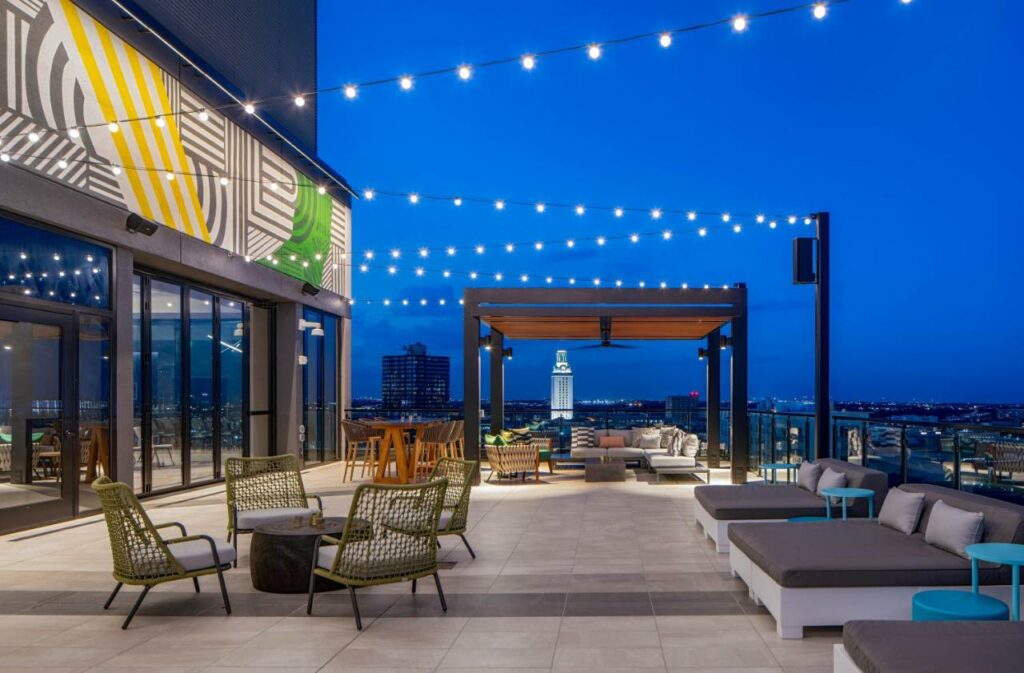 The terrace at the Hilton Garden makes it a popular place to consider when looking for where to stay in Austin: at night the lights glow against the blue sky. 