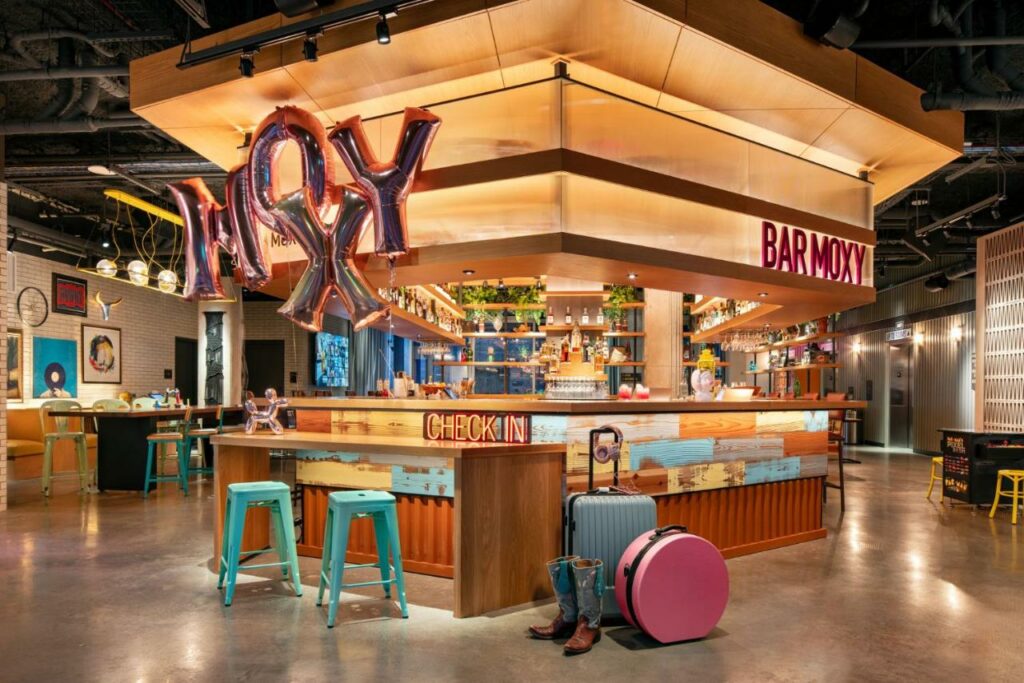 The Moxy University hotel has a unique vibe, making it where to stay in Austin. This stunning bar with 90's vibes for example is themed for the whole hotel.