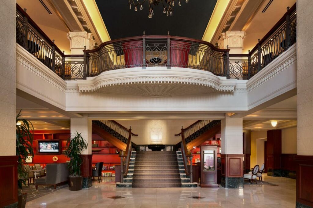 The hotel entrance of the Stephen F Royal Hotel features a grand stair case and terrace. It is where to stay in Austin. 