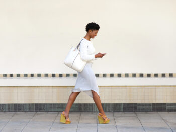 woman walking along the streets of dallas in a cute outfit